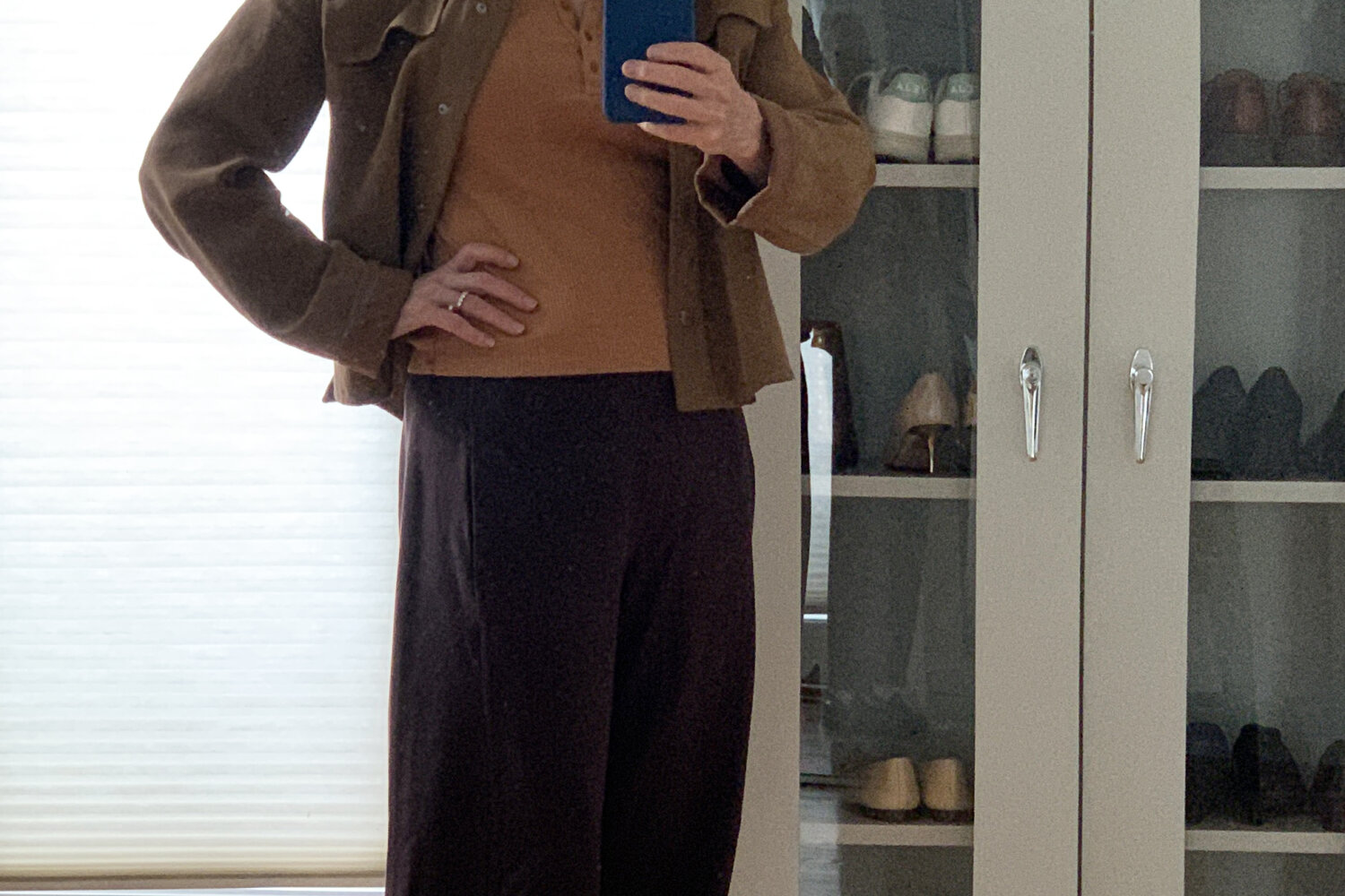 White-haired woman wearing lantern pants by Eileen Fisher in an outfit in shades of brown