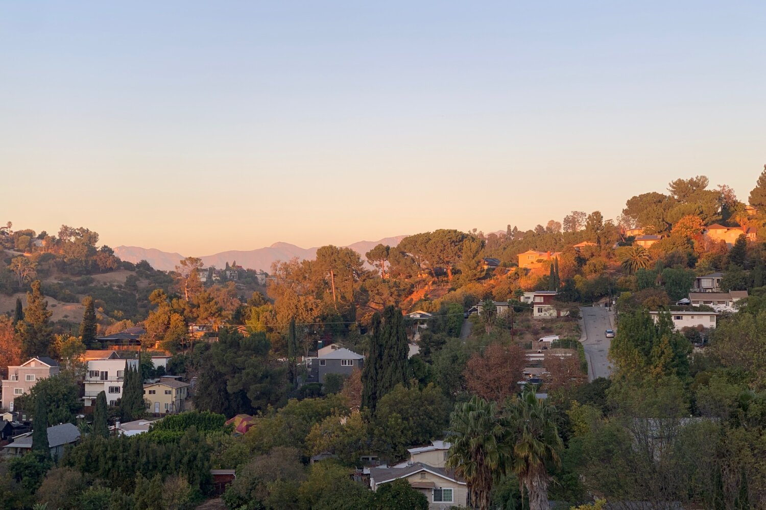 View from Mt. Washington, LA. Sunrise on the far hills and houses in near shadow