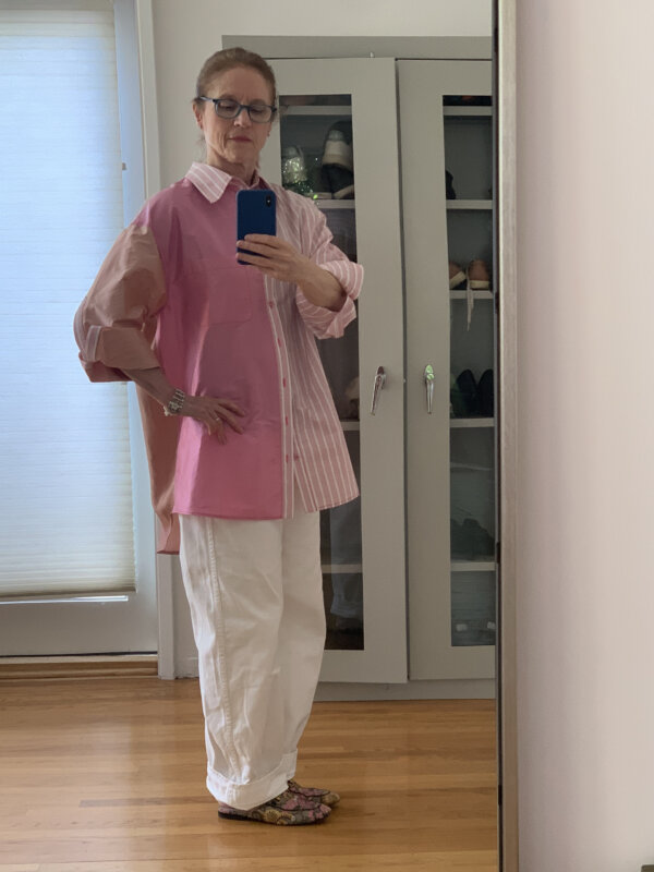 Older woman wearing CJR shirt, white jeans, and Gucci slides
