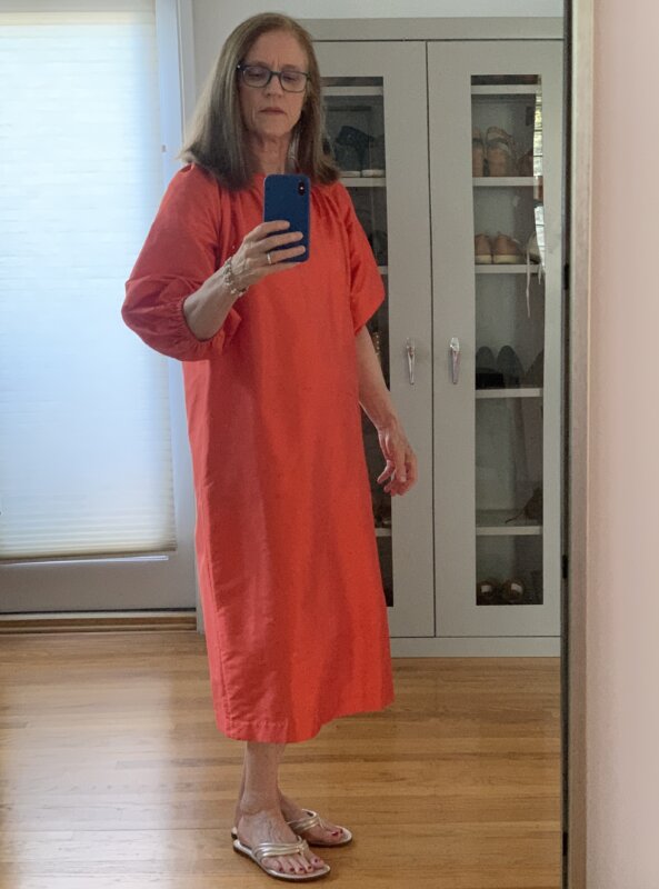 Woman in an orange silk dress