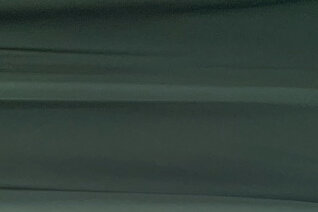 Swatch of dark green silk satin.